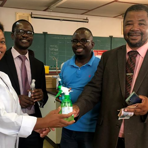 Dr. Thabile Ndlovu (left) presents hand sanitizer produced at the University of Eswatini to Vice-Chancellor Prof. Justice Thwala.