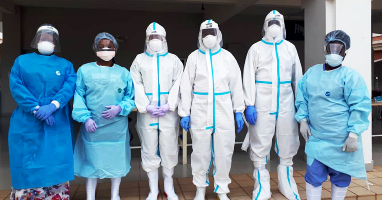 Scientists at Malawi University of Science and Technology in full personal protective equipment, preparing to analyze COVID-19 tests kits